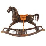 A decorative carved wooden rocking horse, 124cm long x 84cm high