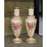 A pair of late 19th Century Royal Worcester vases, decorated floral sprays heightened in gilt on a