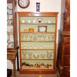 A walnut open fronted bookcase, of tall proportions, fitted adjustable shelves, raised on a platform