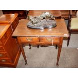 A Georgian oak low boy, the overhanging top above two short drawers above a shaped frieze raised