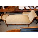 A  Victorian walnut chaise longue, upholstered in pale dralon, having acanthus scrolled