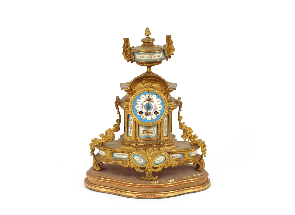 A 19th Century French ormolu mantel clock, with Sevres type panels, decorated with flowers and
