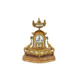 A 19th Century French ormolu mantel clock, with Sevres type panels, decorated with flowers and