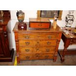 A 19th Century continental walnut chest, fitted four long drawers and brushing slide, flanked by