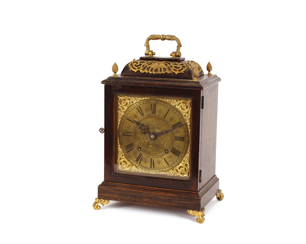 An early 20th Century oak cased and brass mounted bracket clock, having pierced foliate decoration