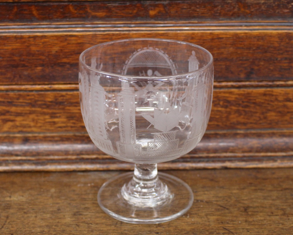 A Masonic etched glass rummer, decorated with symbols, raised on a circular spread foot, 12.5cm