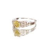 An antique fancy yellow diamond and 18 carat white gold ring, the central stone approx. 1/2 carat,