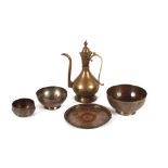 A late 19th Century Russian brass ewer, marked under lid; two Islamic copper bowls; a copper under-