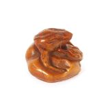 A small Chinese carving of a frog, seated with a serpent