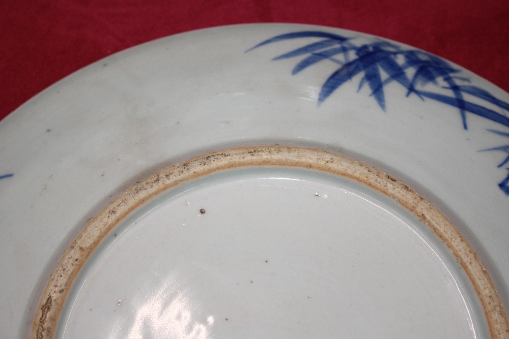 A Chinese blue and white shallow dish, the central field decorated with flowers, 20.5cm dia. six - Image 6 of 13