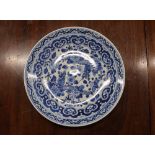 A Chinese blue and white shallow dish, the central field decorated with flowers, 20.5cm dia. six