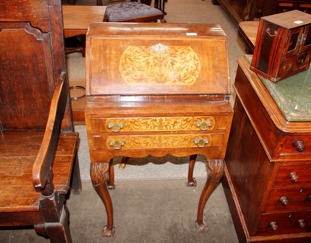 A walnut ladies writing bureau, of small proportions, the inlaid drop front revealing an interior