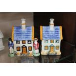 An Antique Staffordshire pearlware cottage moneybox, decorated with figures beside a cottage, 13cm