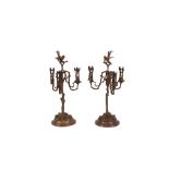 A pair of 19th Century copper and plated three light candelabra, of rustic design, surmounted by