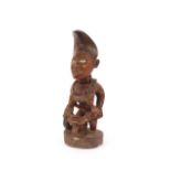 A well carved West African wood fertility figure, having glass eyes, 44cm high