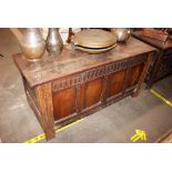 An 18th Century oak coffer, with four panelled front, raised on square section supports, 139cm wide