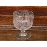 A Masonic etched glass rummer, decorated with symbols, raised on a circular spread foot, 12.5cm