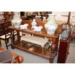 A late Victorian oak two tier serving table, raised on bold baluster turned supports, 191cm wide