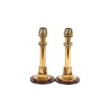 A pair of unusual brass candlesticks, formed from WW2 bomb detonators and raised on square socles
