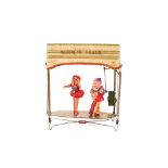 A Japanese tin plate mechanical marionette theatre, 24cm long x 25cm high