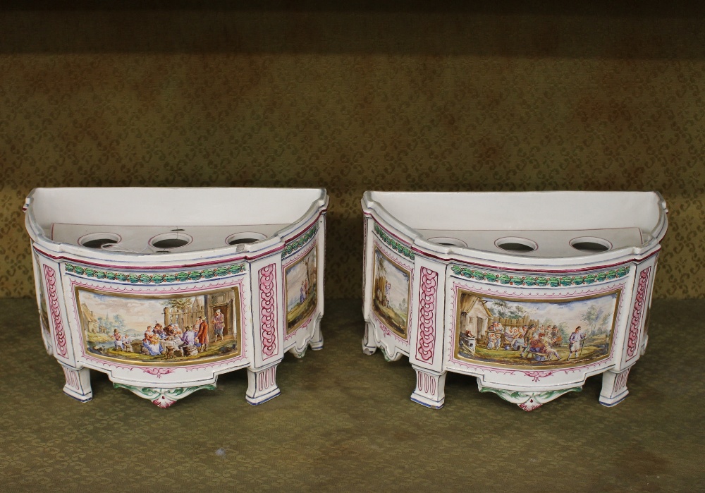 A pair of 19th Century French porcelain bough pots, of demi lune shape, the panels decorated with