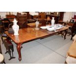 A Victorian mahogany extending dining table, fitted three extra leaves and raised on bold acanthus