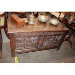 A large 18th Century carved oak coffer, 126cm wide