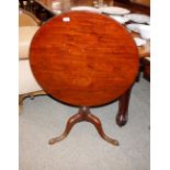 A Georgian circular mahogany tripod occasional table, raised on a turned baluster column and