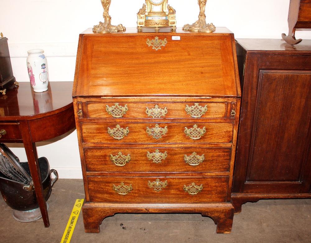 A George III mahogany bureau, of small proportions, the fall front opening to reveal an interior