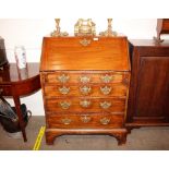 A George III mahogany bureau, of small proportions, the fall front opening to reveal an interior