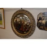 A circular gilt framed convex wall mirror