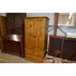 A modern pine double wardrobe fitted two short and