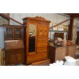 A late Victorian satin wood wardrobe fitted four d