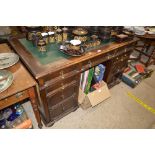 An oak twin pedestal writing desk with green leath