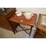 An oak side table raised on cross framed stretcher