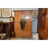 A 20th Century oak single door mirrored wardrobe