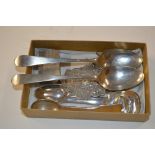 A box containing mixed silver spoons, a silver matc