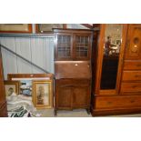 An oak and leaded glazed bureau bookcase fitted si