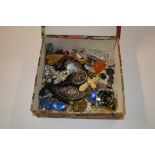 A box containing various costume jewellery, beads