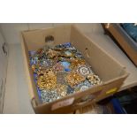 A box of costume jewellery - mostly brooches