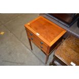 A reproduction yew wood two drawer bedside table