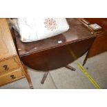 A reproduction mahogany drop leaf dining table