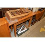 A light oak hall table fitted three drawers