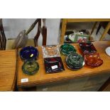 A collection of various glass ash trays and bubble