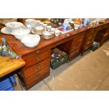 A mahogany writing desk fitted nine drawers