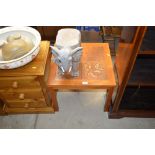 A teak and tile topped coffee table