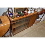 An oak bookcase with sliding glass doors