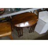 A nest of three mahogany occasional tables