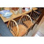 A pair of light Ercol elm stick back kitchen chair