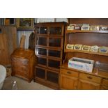 An oak Oxford five tier and glazed sectional bookc